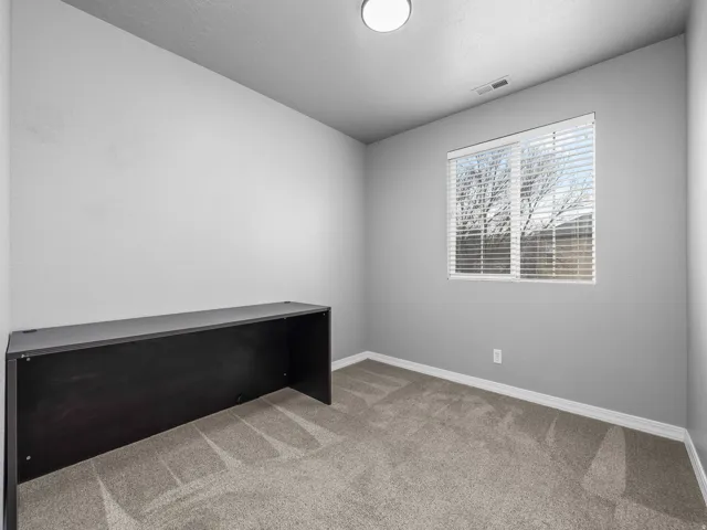Spare room with light colored carpet and baseboards