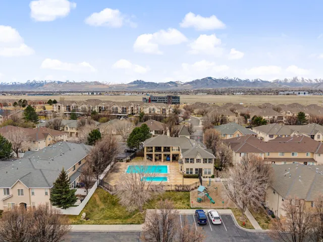 Aerial perspective of suburban area with a pool area and a mountain backdrop
