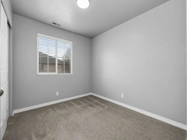 Unfurnished room with carpet and baseboards