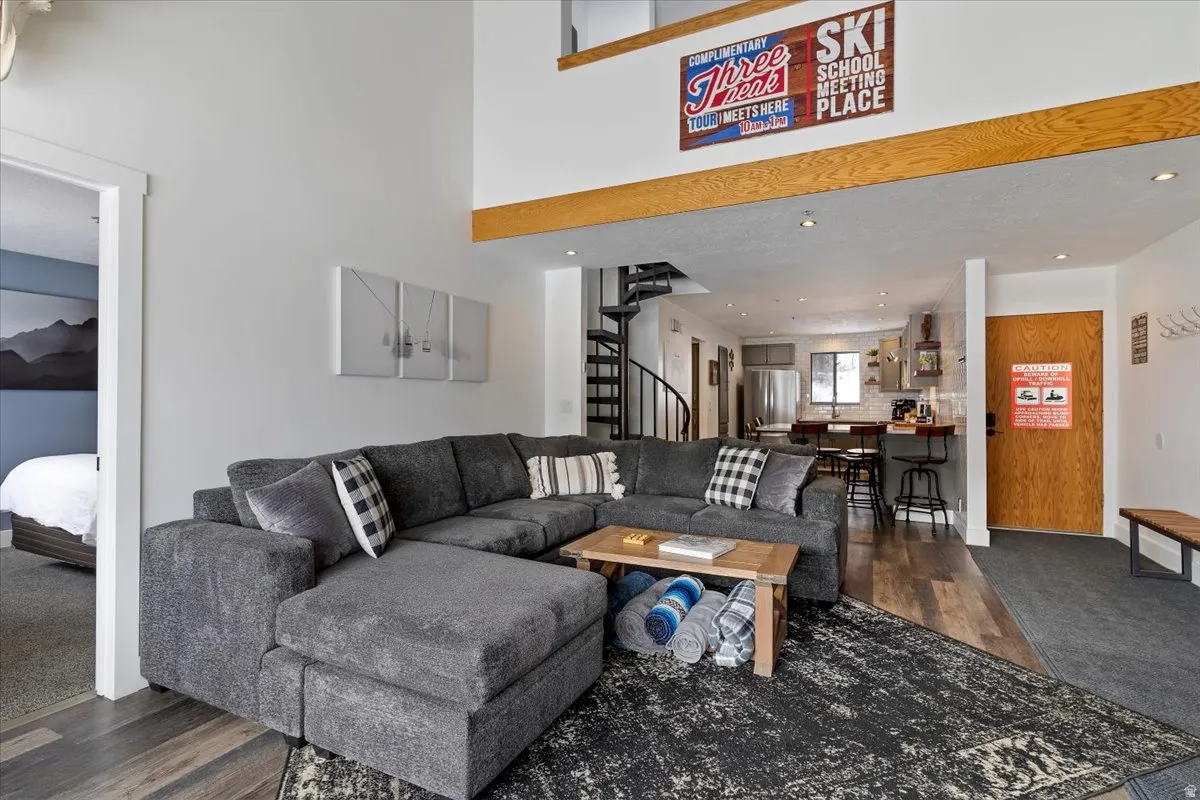 Living area featuring dark wood-style flooring and recessed lighting