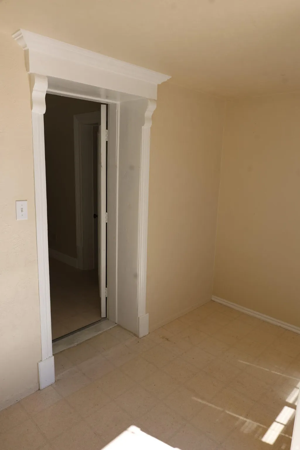 Unfurnished room with light flooring