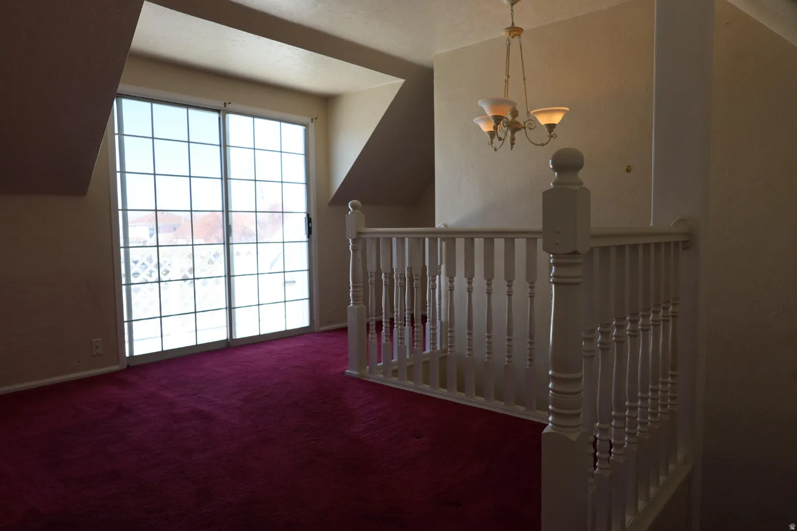 Stairway with suspended lighting and carpet floors