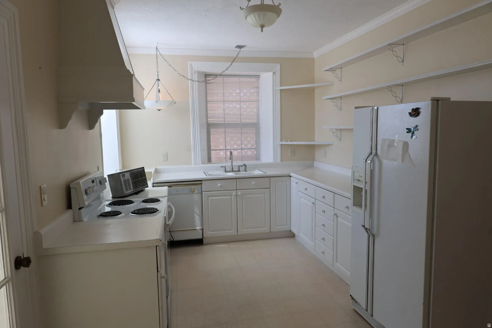 Kitchen featuring white appliances, light countertops, open shelves, white cabinets, and light floors