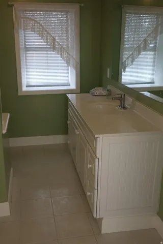 Bathroom with vanity and light tile patterned flooring