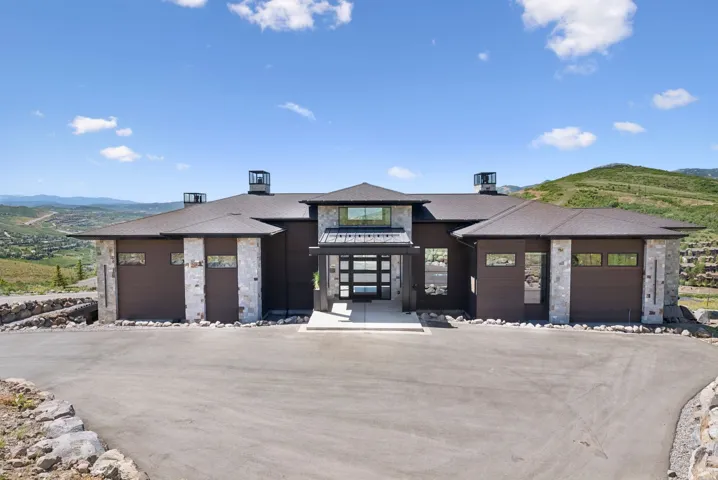 View of building exterior featuring a mountain view and a garage
