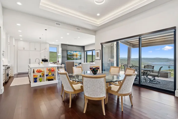 Dining area with dark wood finished floors, recessed lighting, a raised ceiling, and a mountain view