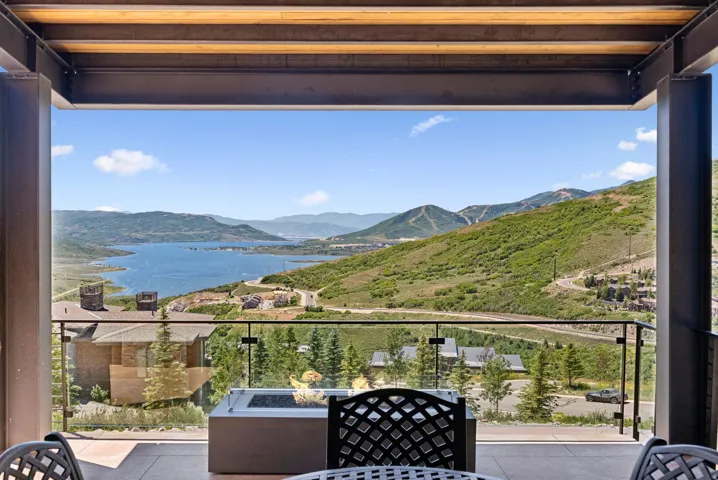 Balcony featuring a water and mountain view