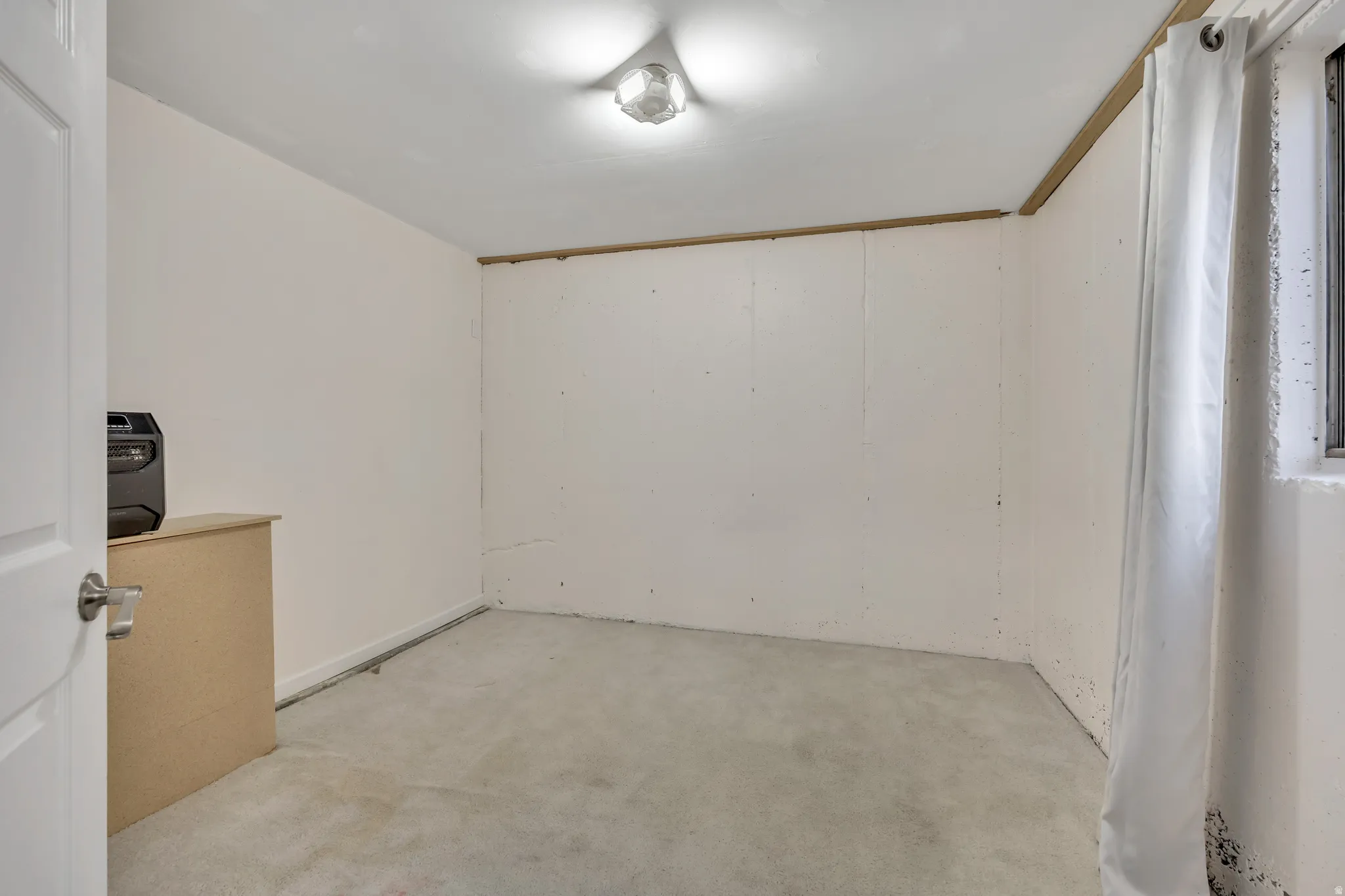 Unfurnished room featuring light colored carpet