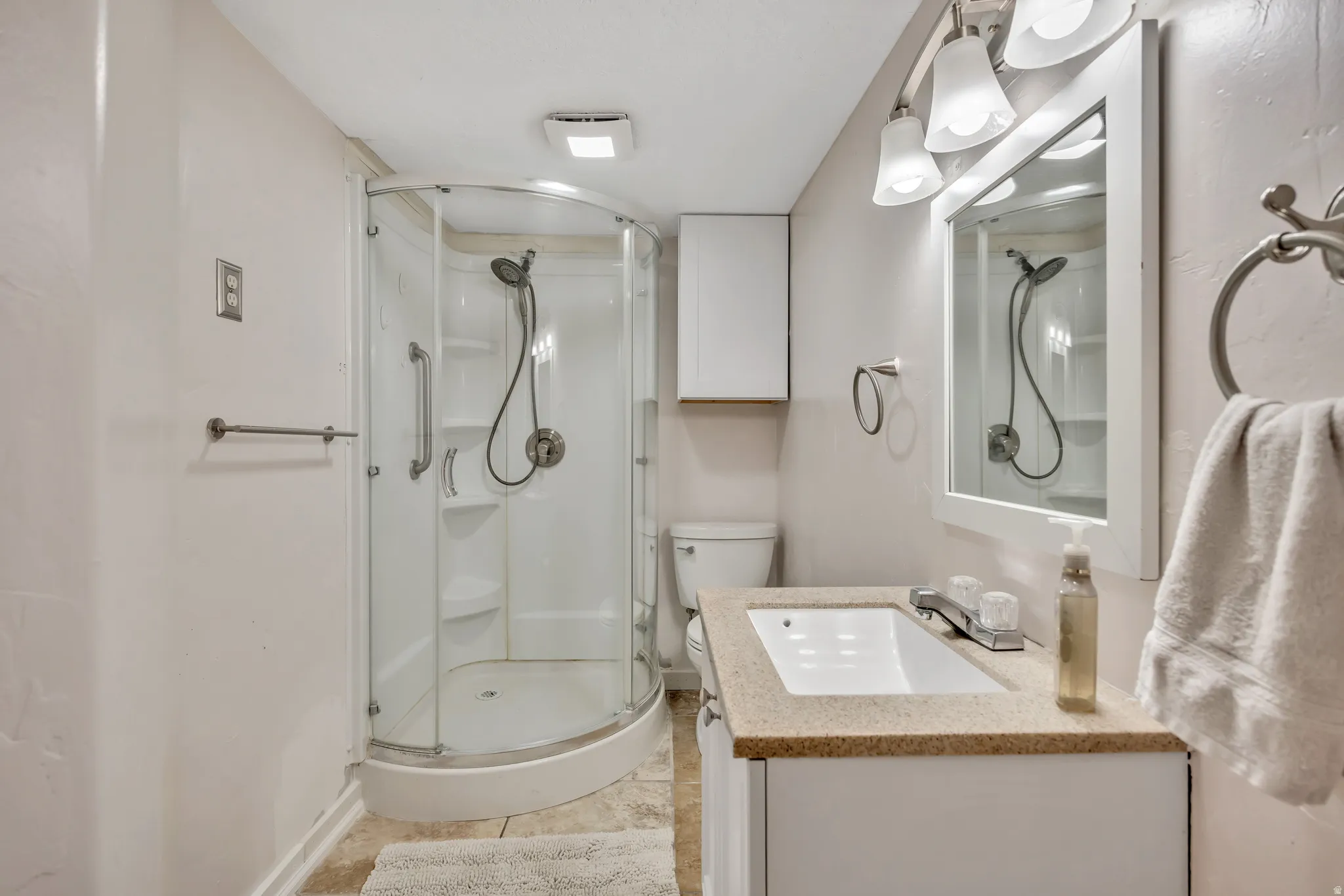 Bathroom with a stall shower and vanity