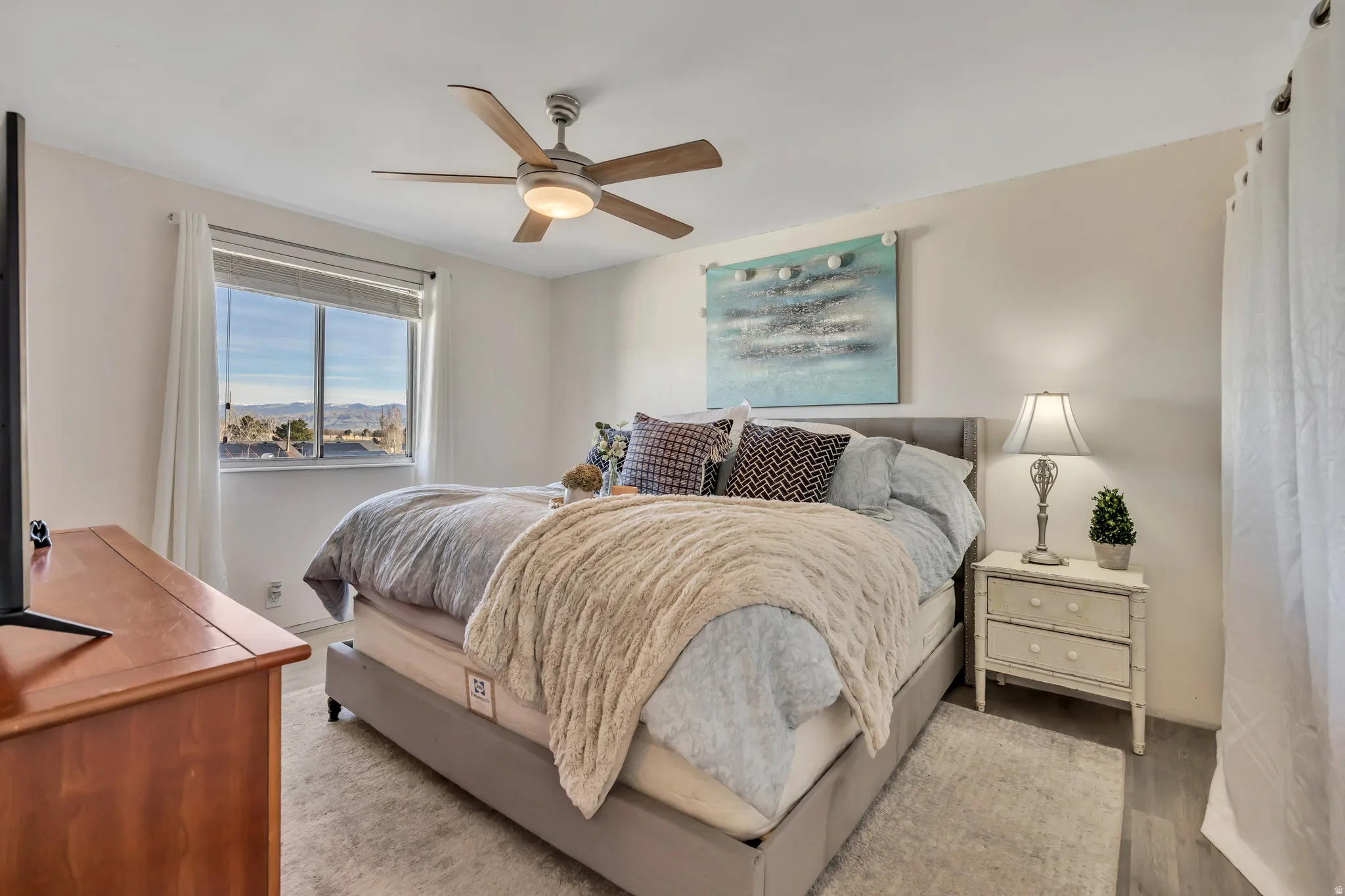 Bedroom with a ceiling fan and light wood finished floors