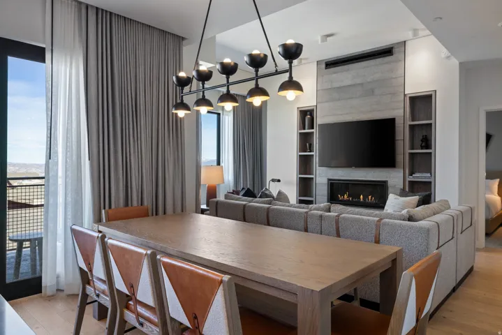 Dining area featuring light wood-style flooring and a fireplace