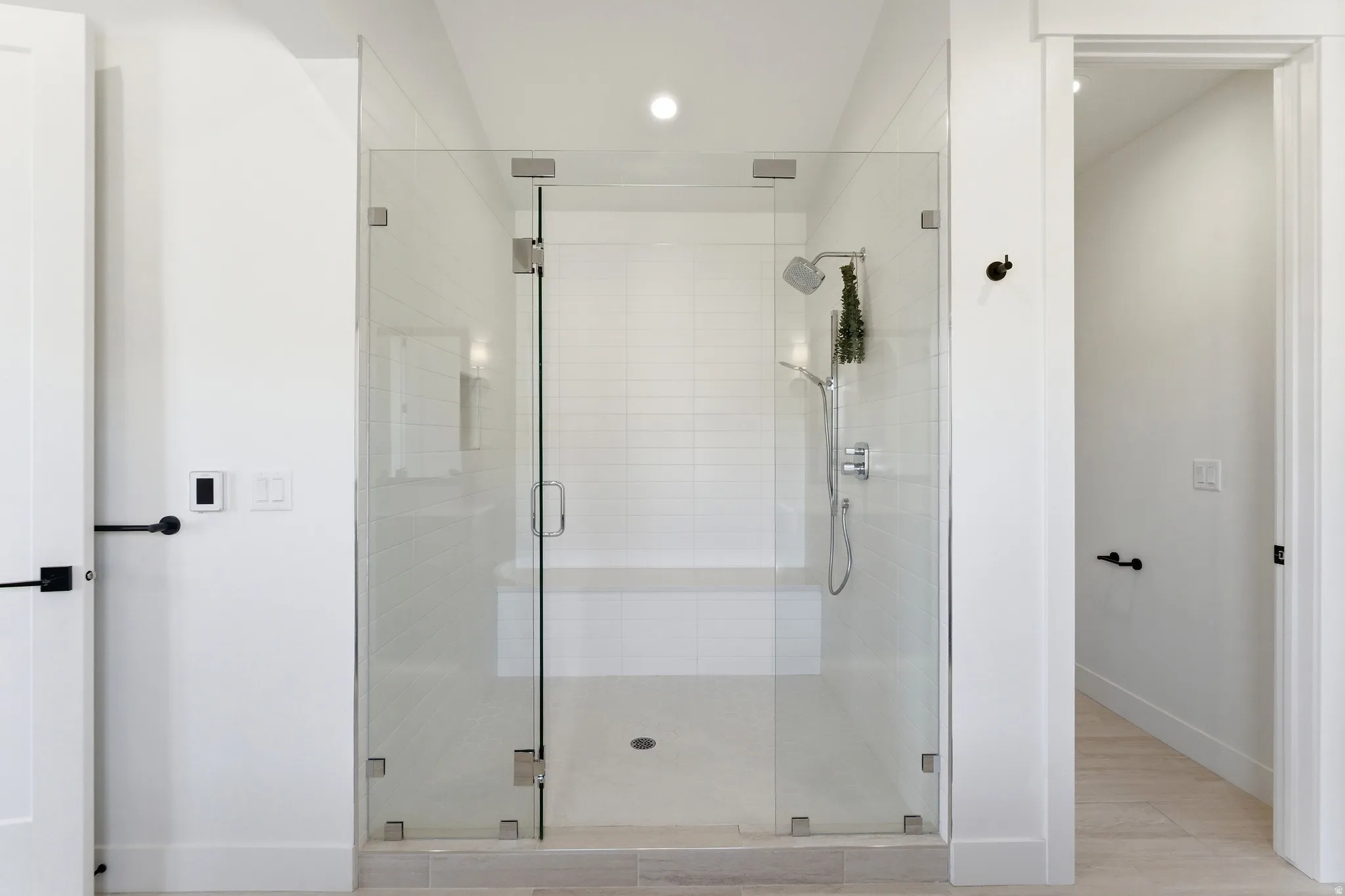 Bathroom with a stall shower and recessed lighting