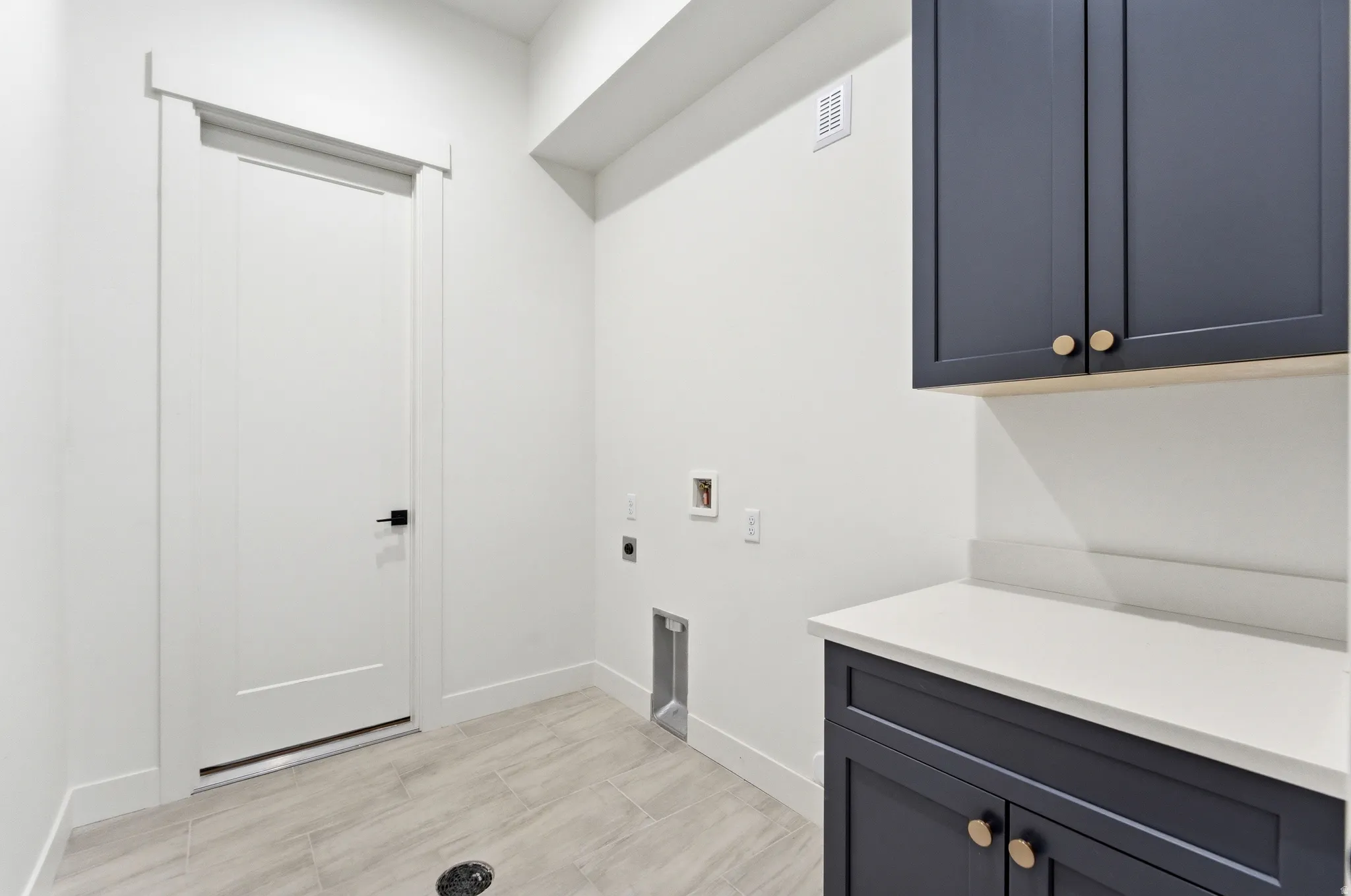 Laundry room featuring washer hookup, hookup for an electric dryer, and cabinet space