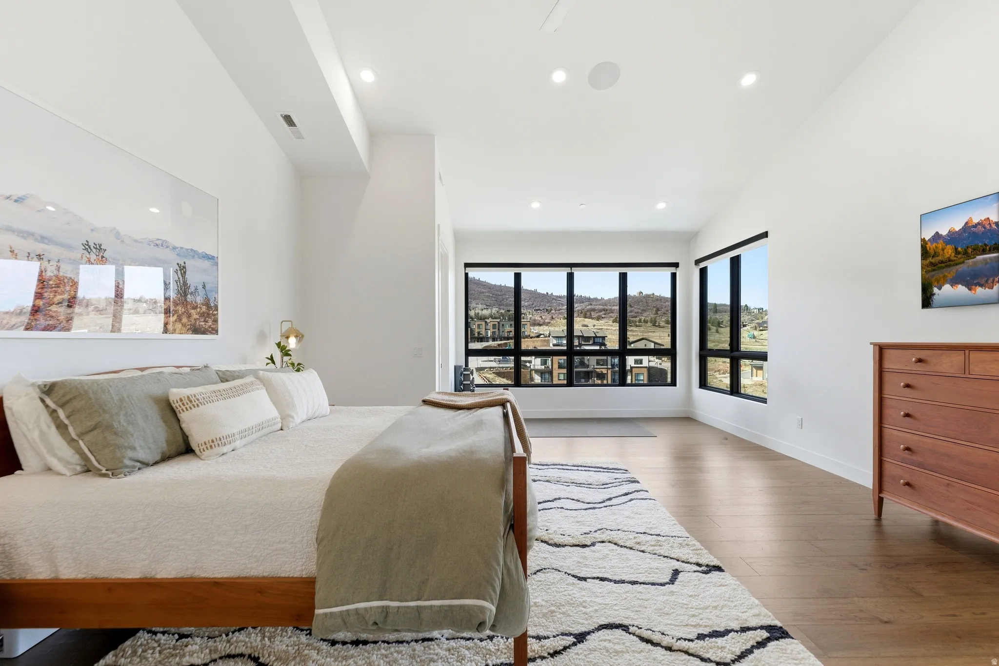 Bedroom with dark wood-style floors, a mountain view, and recessed lighting
