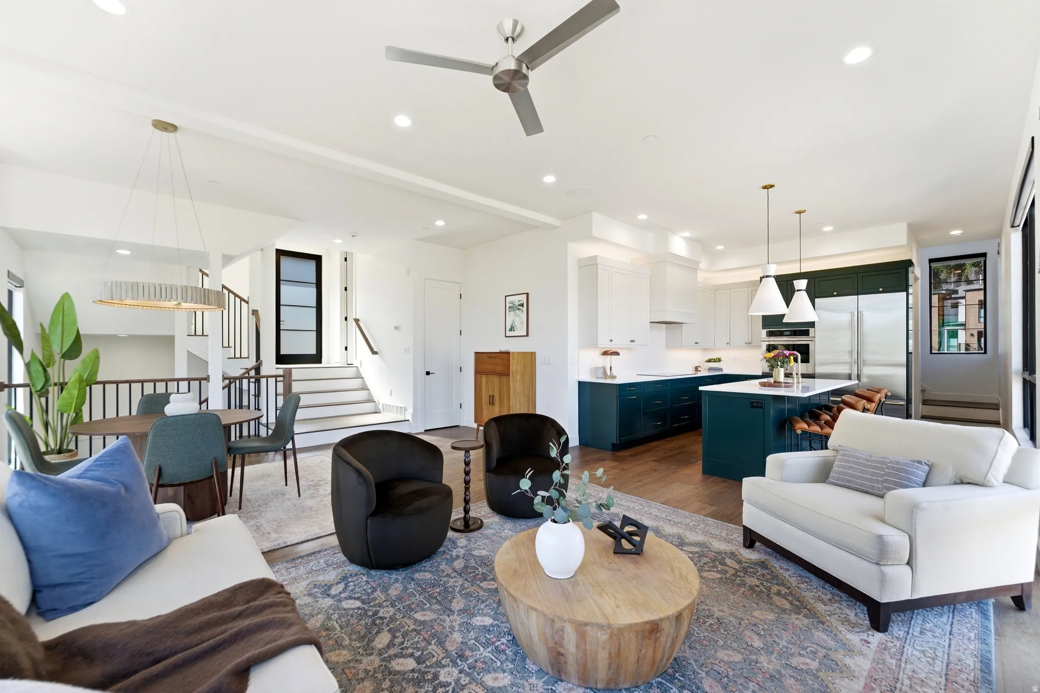 Living room with dark wood finished floors, ceiling fan, and recessed lighting