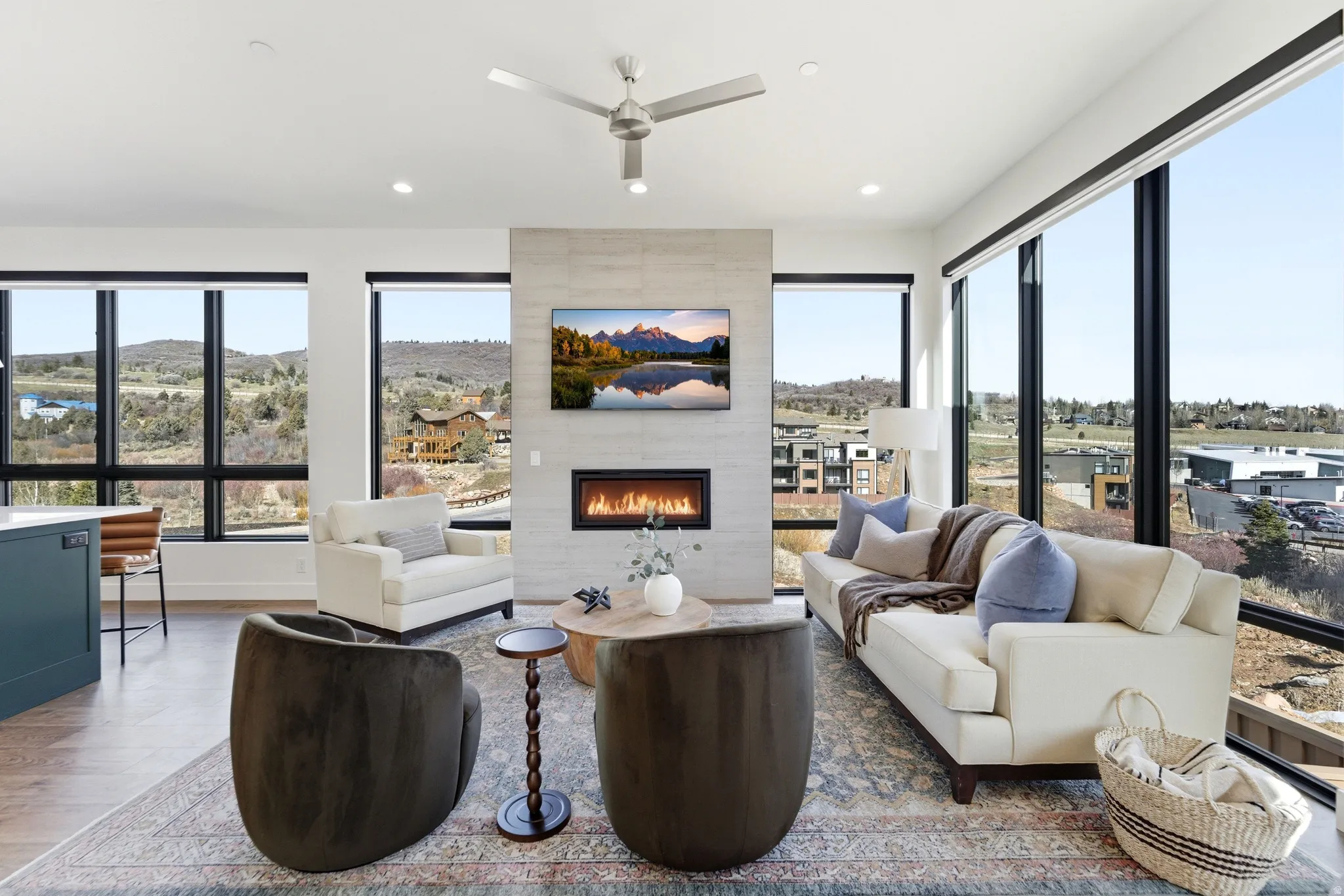 Living area featuring a tile fireplace, ceiling fan, wood finished floors, and recessed lighting