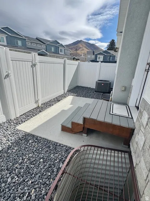 Fenced backyard with a residential view and a patio