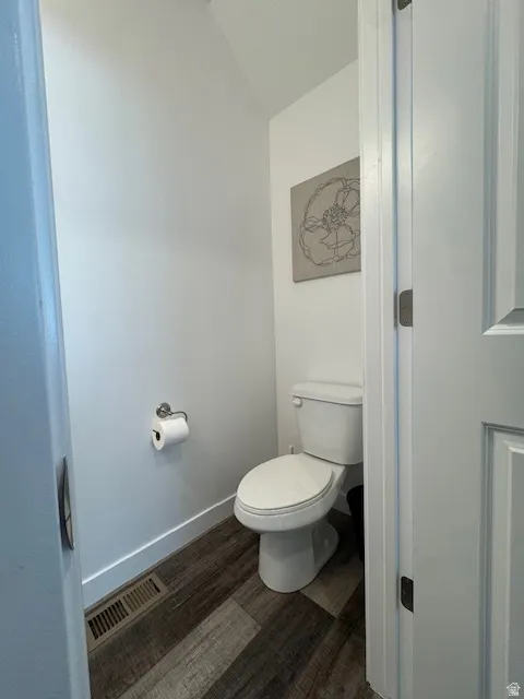 Bathroom with dark wood-style floors and baseboards