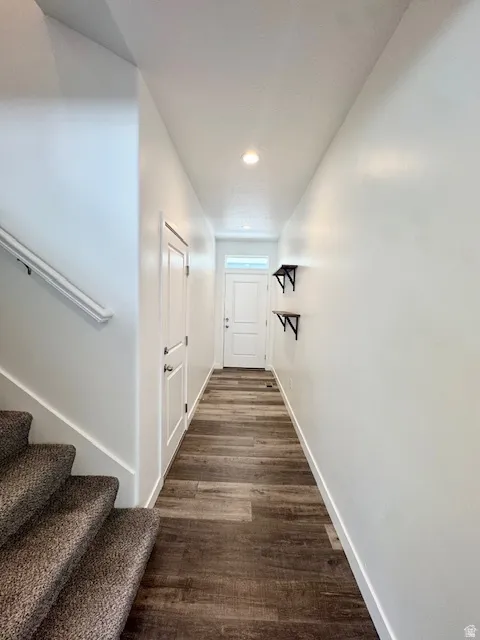 Hallway featuring dark wood-type flooring and recessed lighting