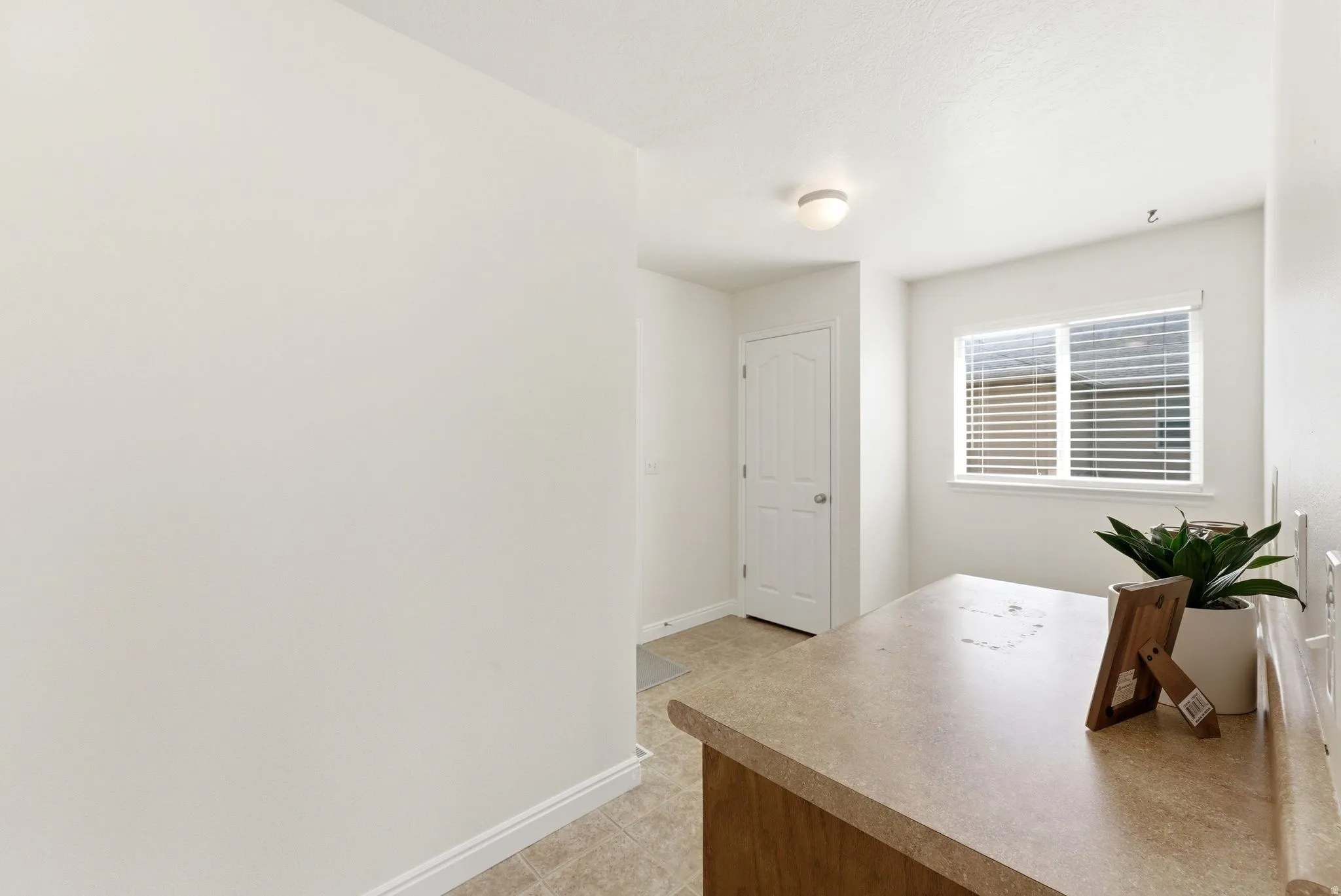 Office area featuring baseboards and light tile patterned flooring
