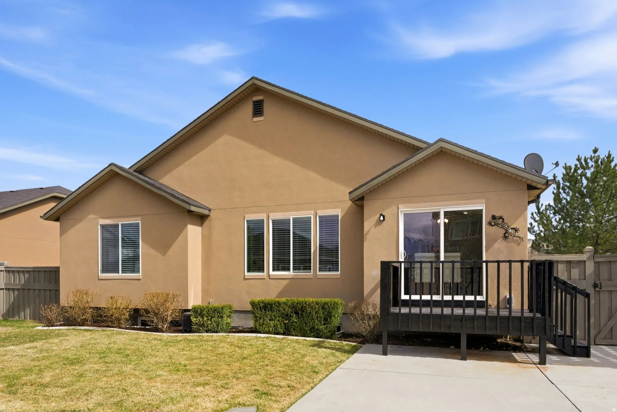 Bungalow-style home featuring a deck and stucco siding