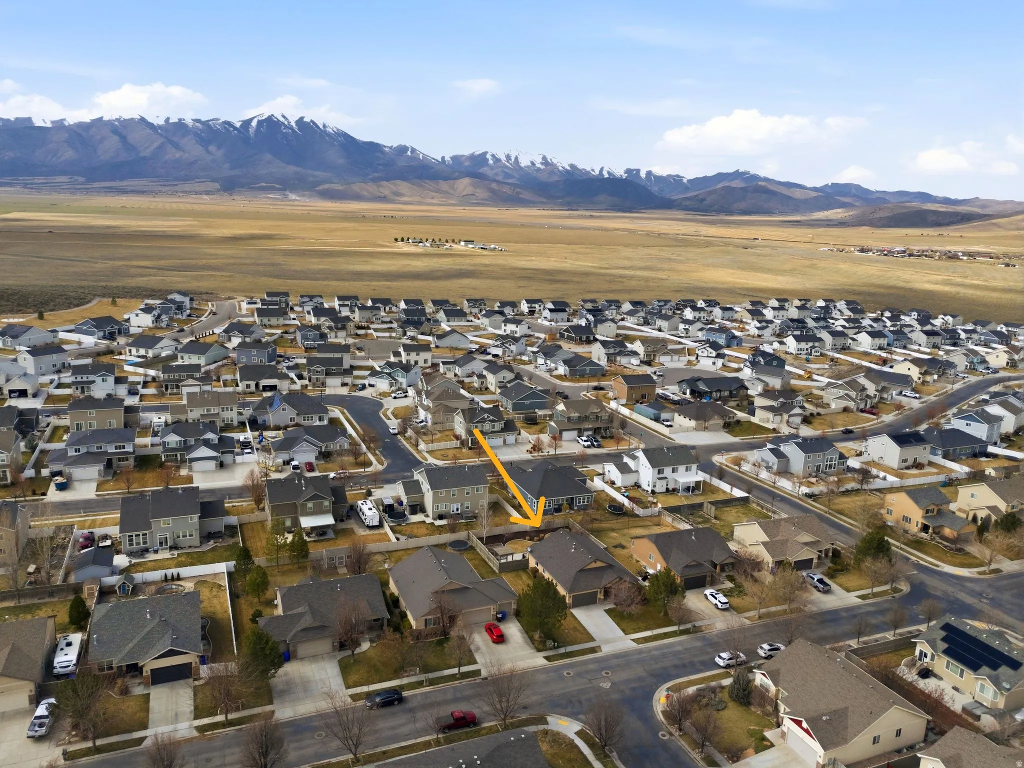 Aerial view of residential area featuring a mountainous background