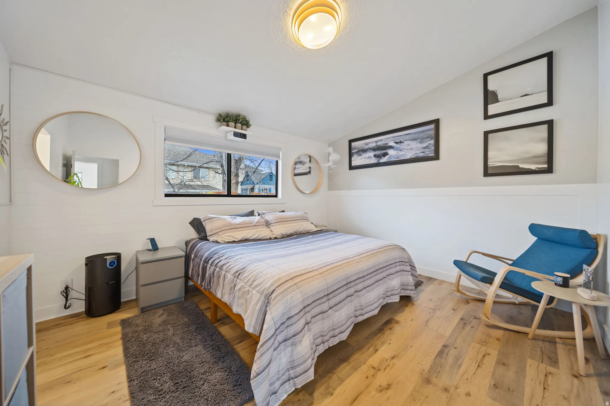Bedroom featuring lofted ceiling and light wood-type flooring