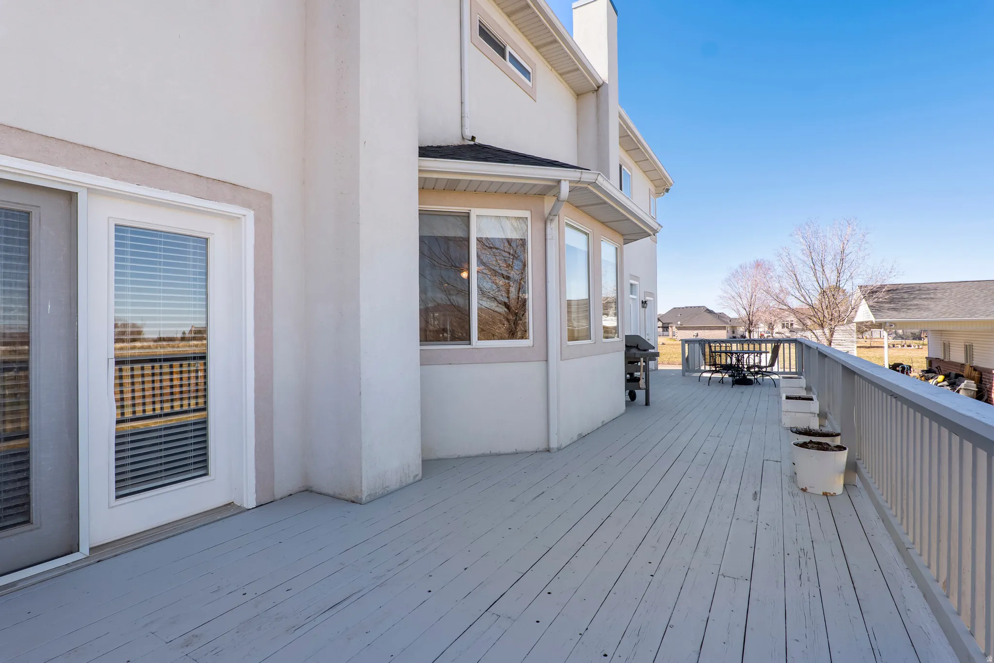 Deck with a grill and outdoor dining area