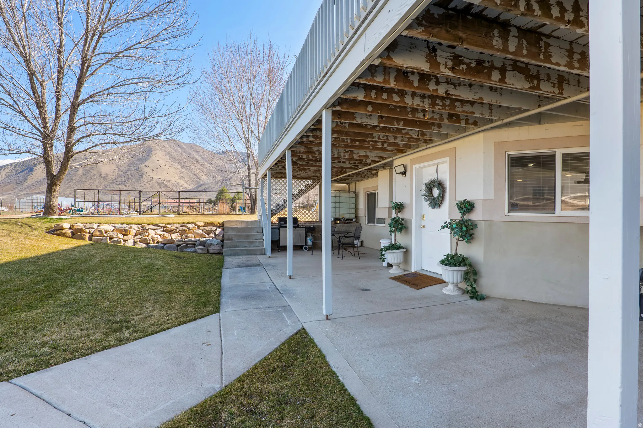 View of patio with a mountain view and area for grilling