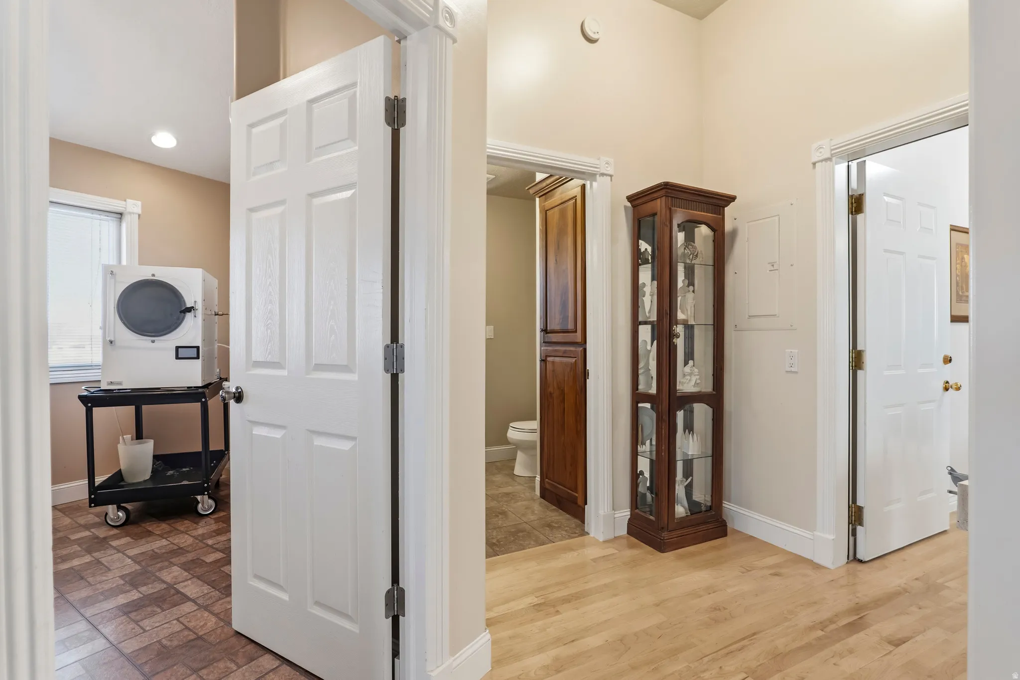 Hallway featuring baseboards and stacked washer and dryer