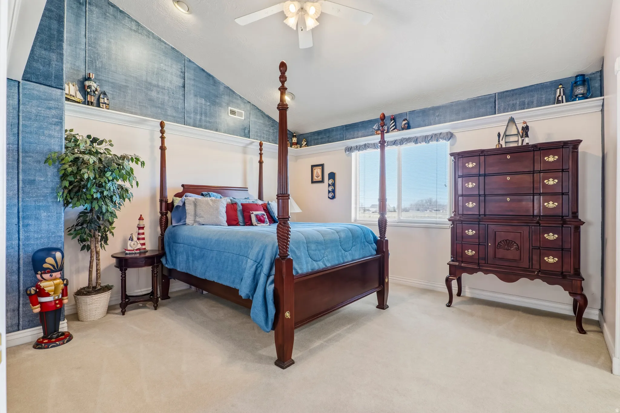 Bedroom featuring lofted ceiling, a ceiling fan, and light colored carpet