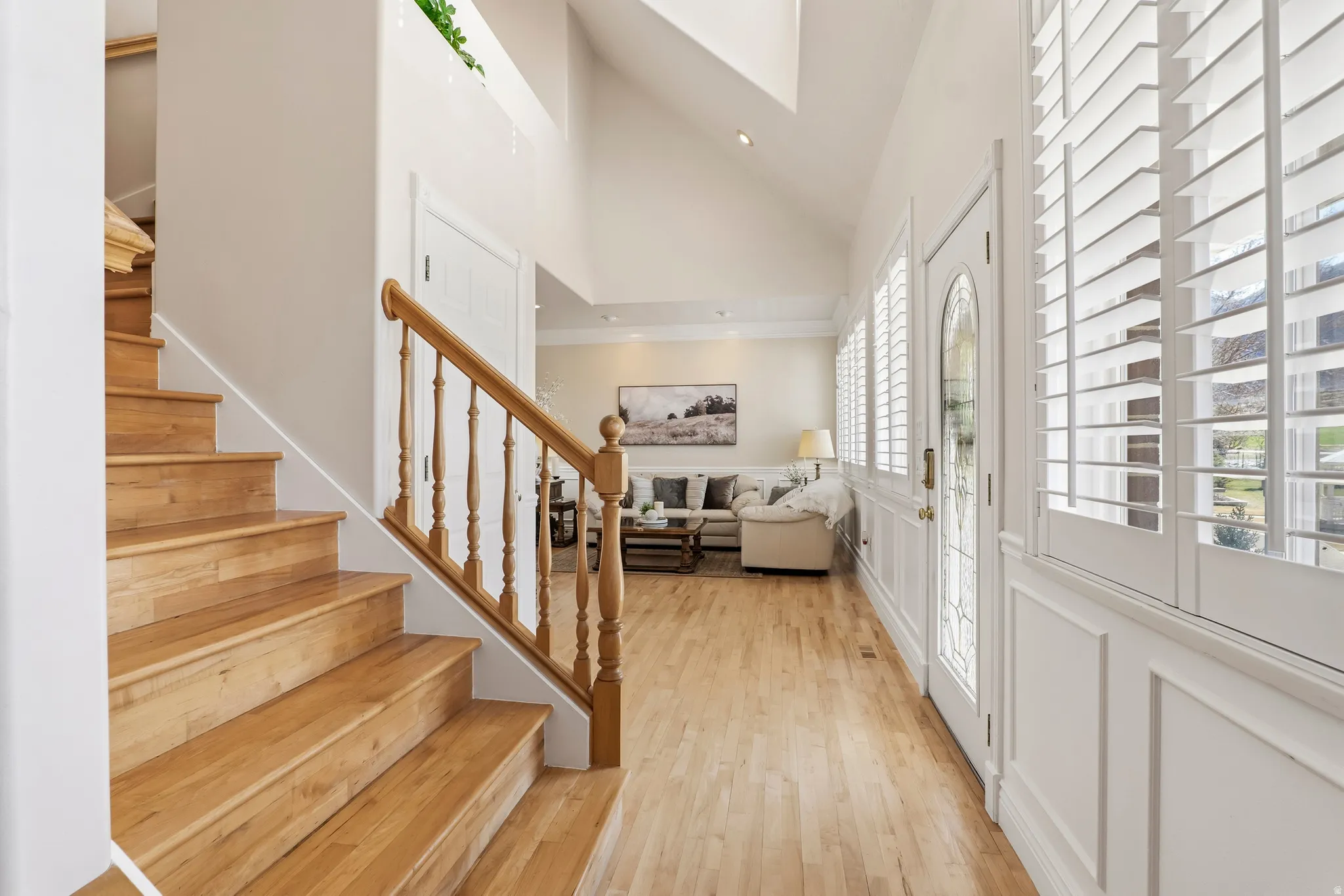 Entryway with light wood-type flooring, lofted ceiling, and recessed lighting