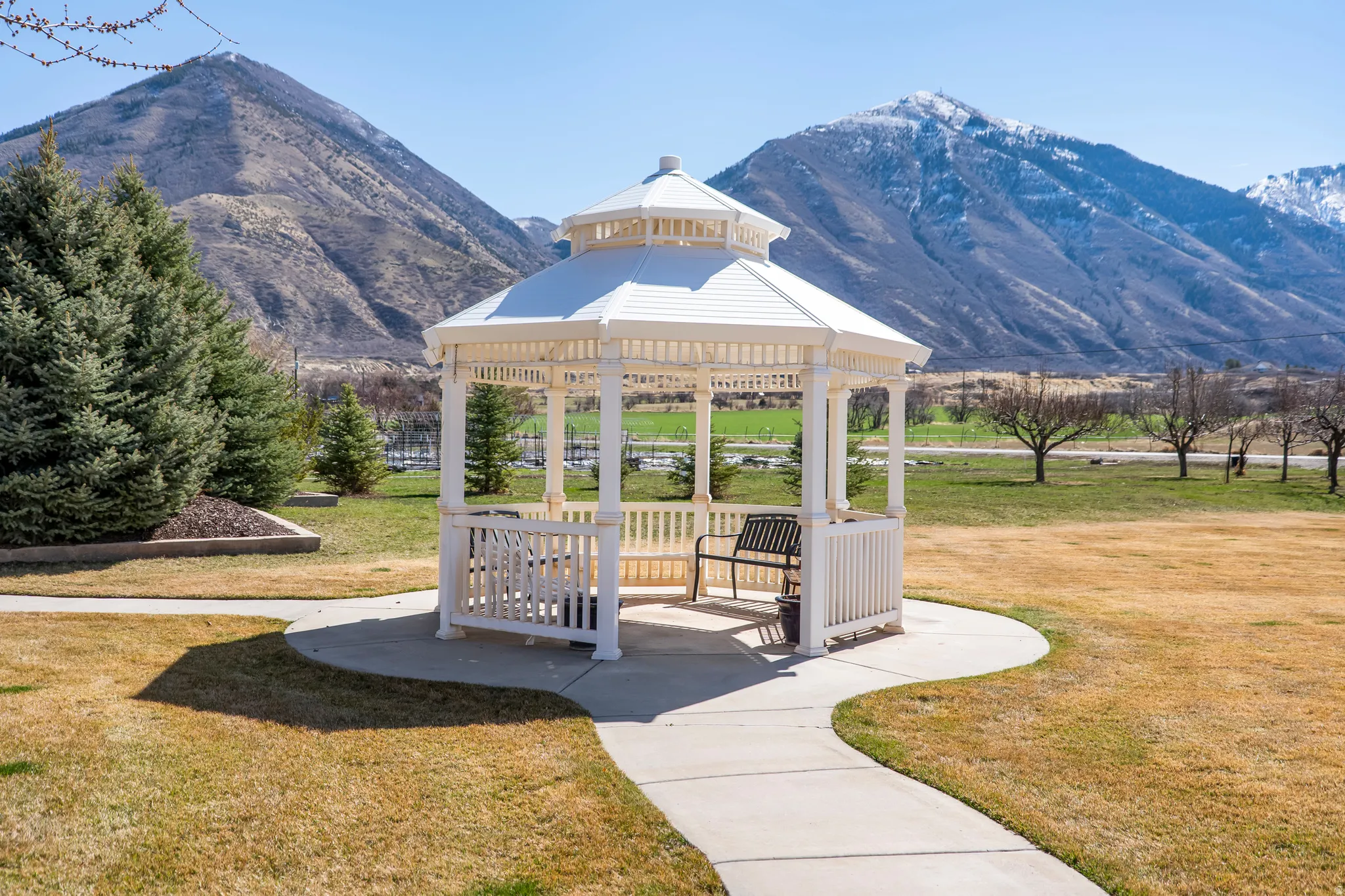 View of property's community featuring a gazebo, a patio area, and a mountain view