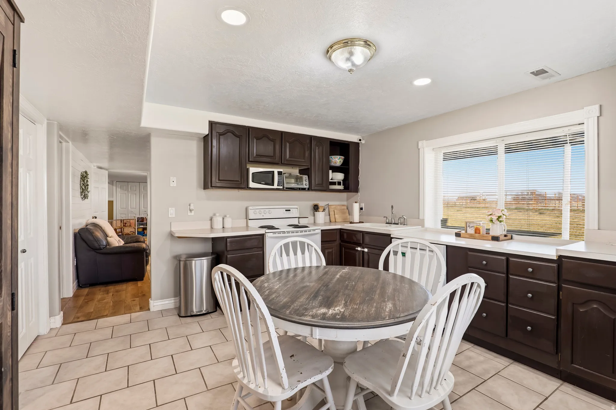 Dining area featuring recessed lighting and light tile patterned floors