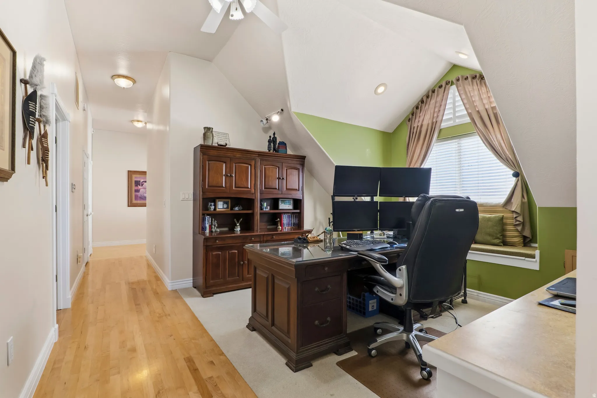 Office featuring light wood-type flooring, a ceiling fan, and vaulted ceiling