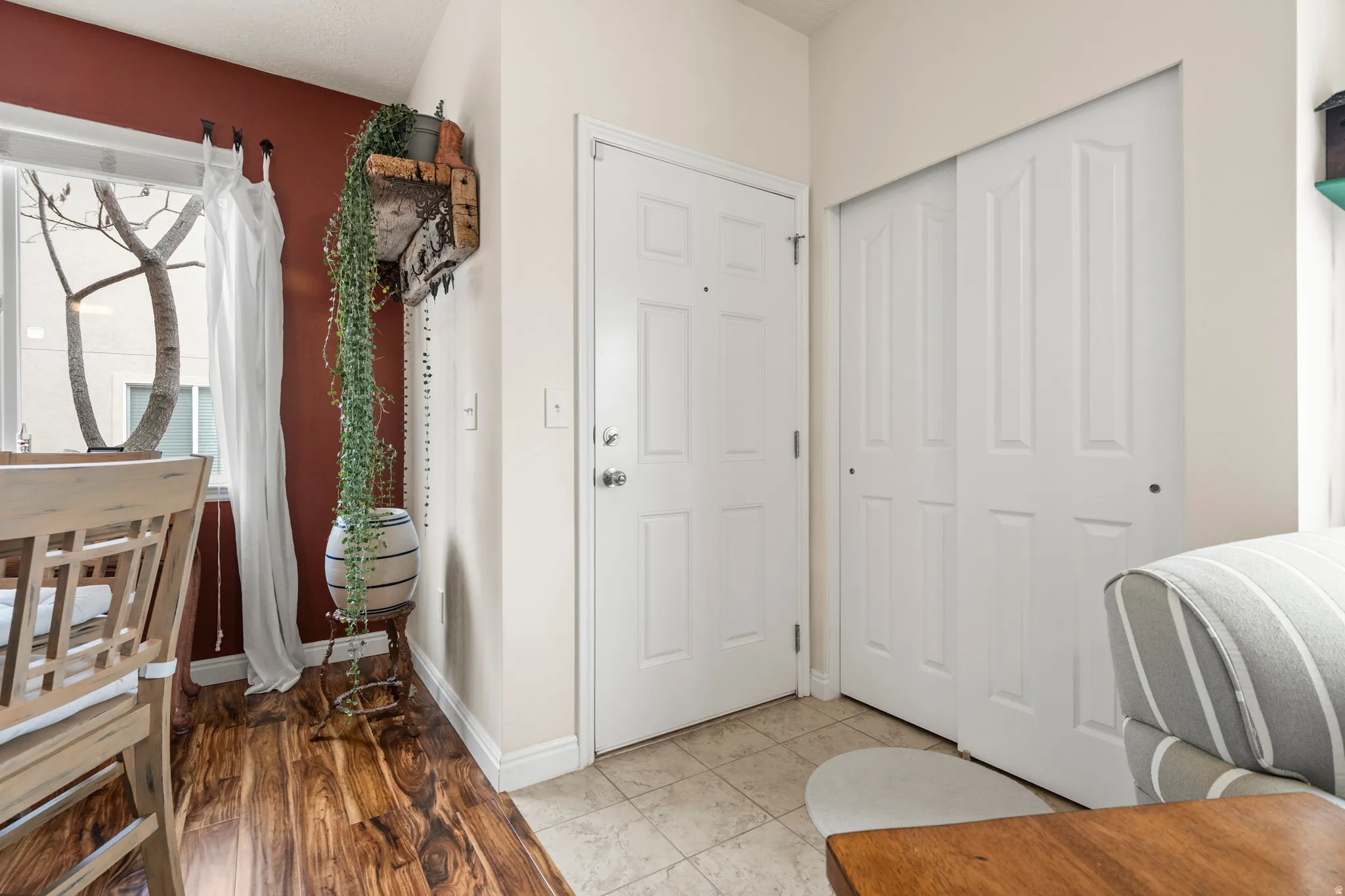 Foyer with light tile patterned floors and healthy amount of natural light