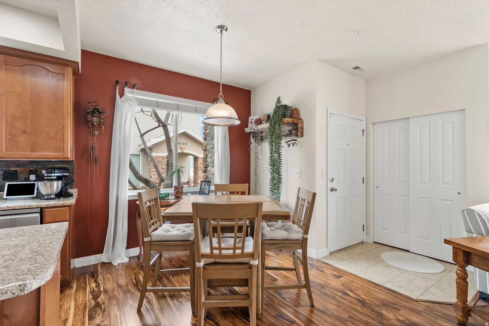 Dining space with dark wood finished floors and a textured ceiling