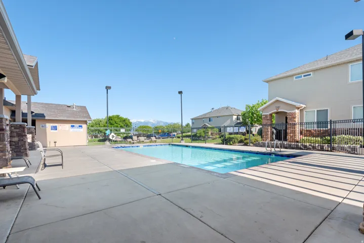 Community pool with a patio area and a mountain view