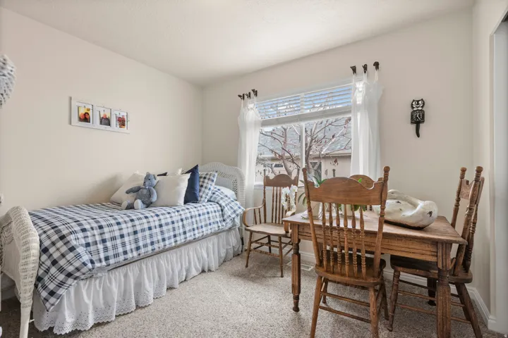 Bedroom featuring carpet floors and baseboards