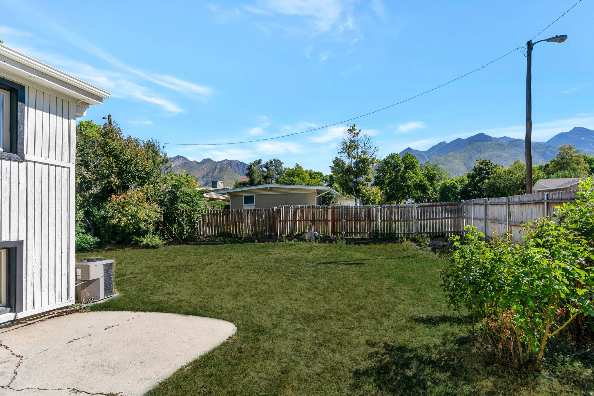 Fenced backyard with a mountain view and a patio