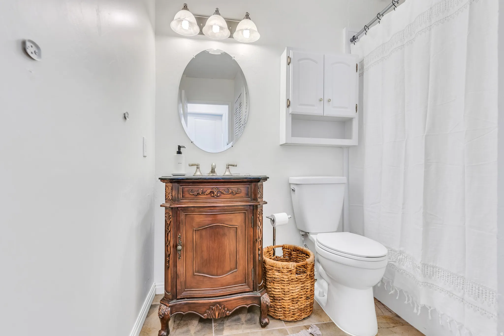 Bathroom featuring vanity and a shower with shower curtain