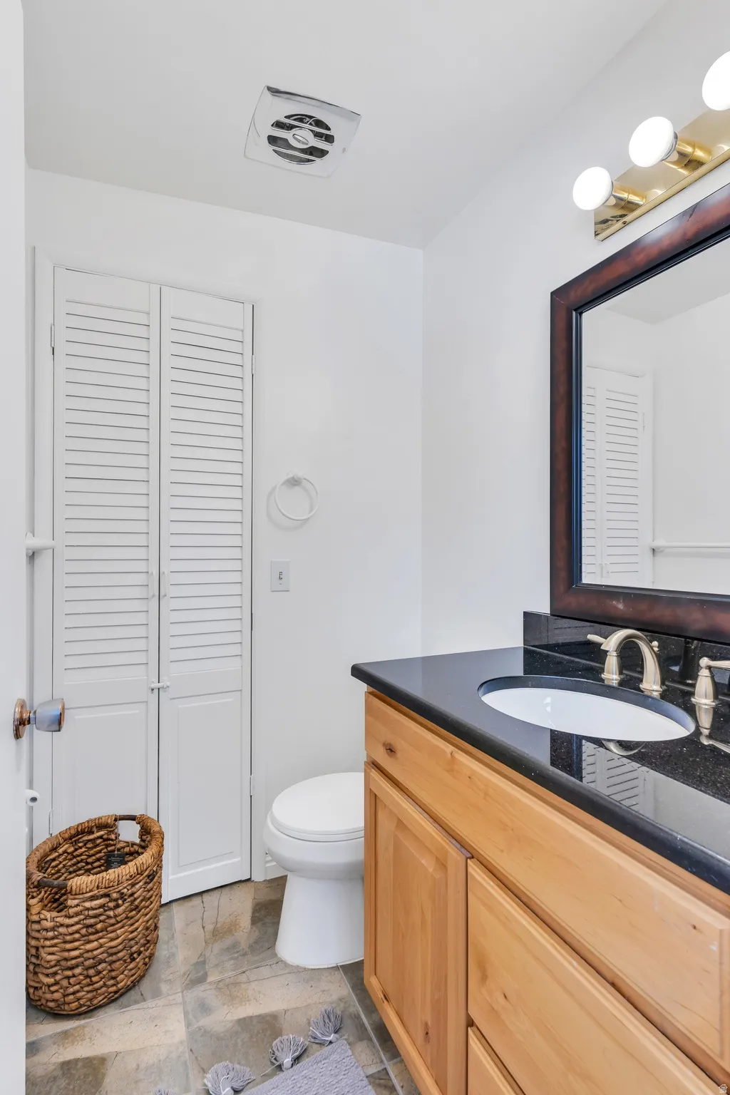 Bathroom featuring a closet and vanity
