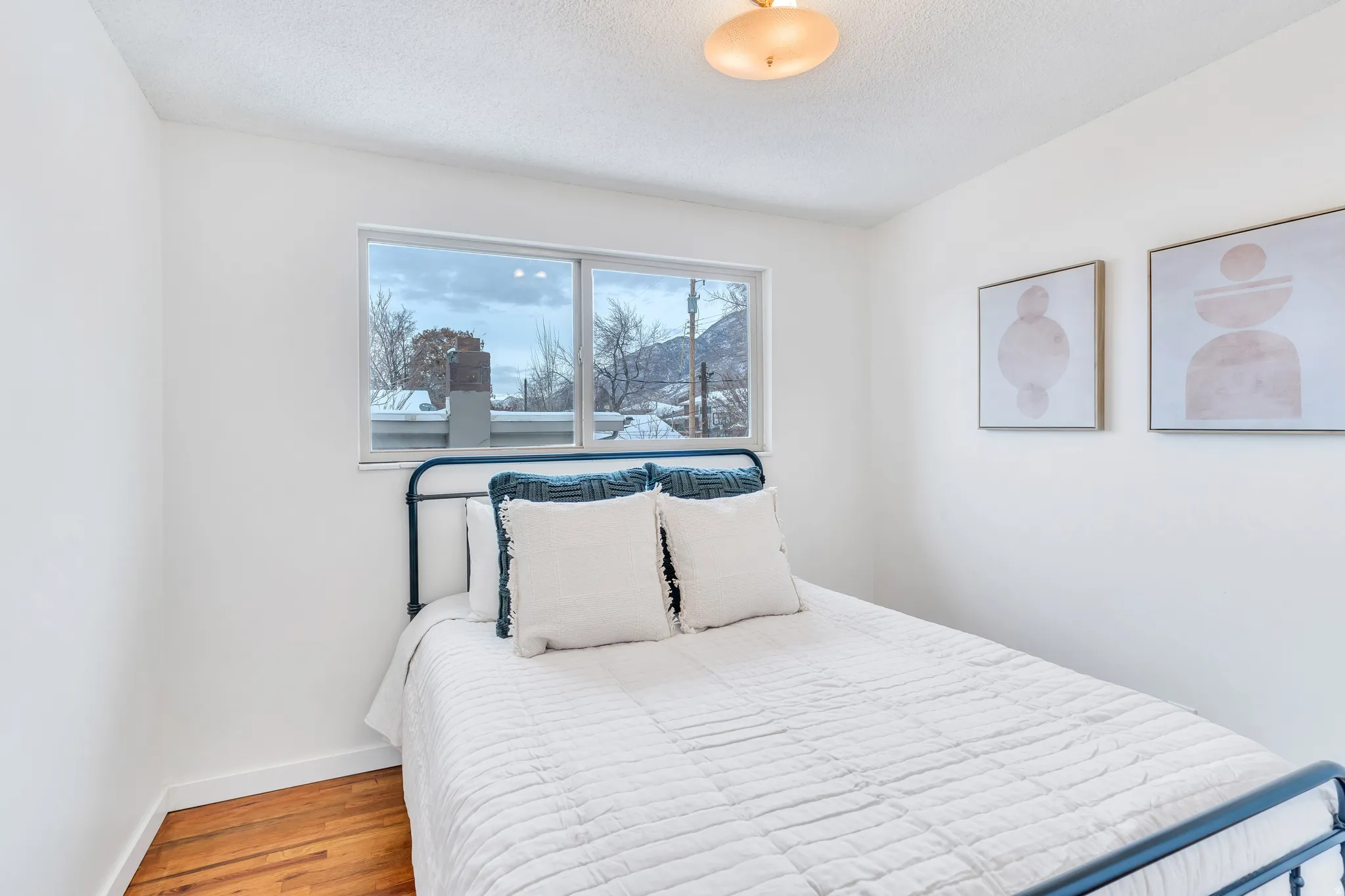 Bedroom featuring wood finished floors and a textured ceiling