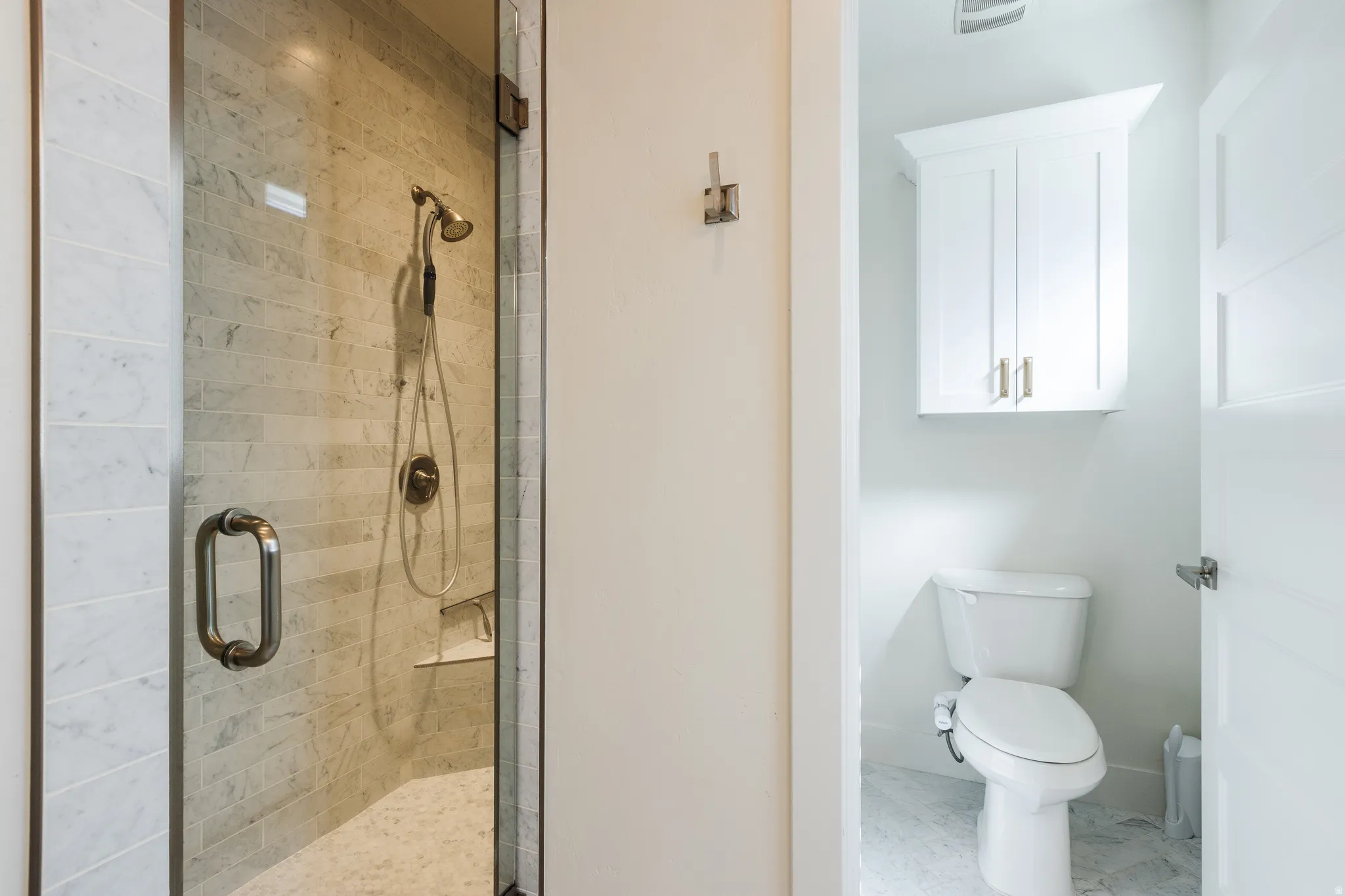 Bathroom featuring a stall shower and toilet