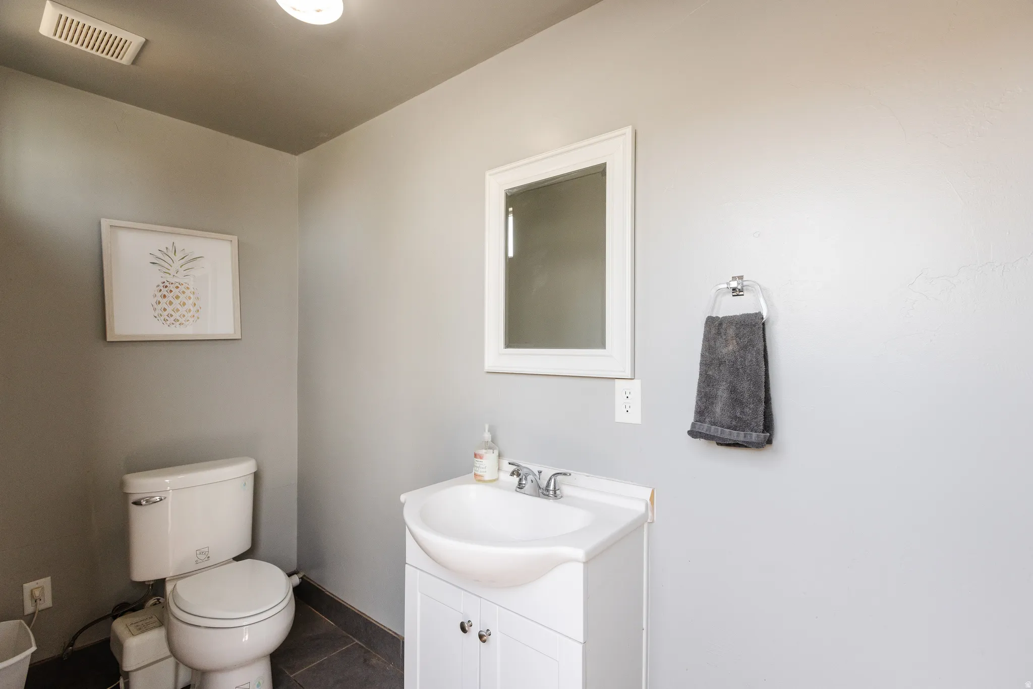 Bathroom with vanity and dark tile patterned floors