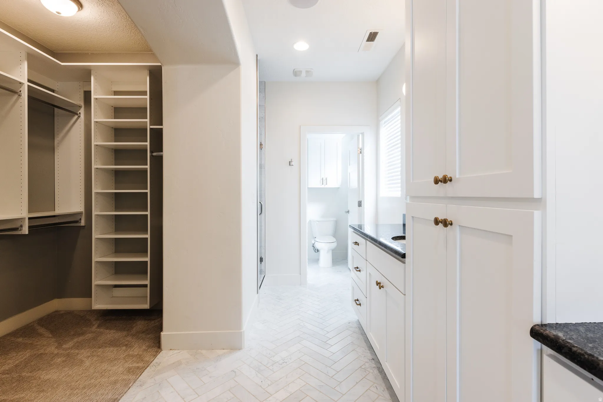 Bathroom featuring vanity and a spacious closet
