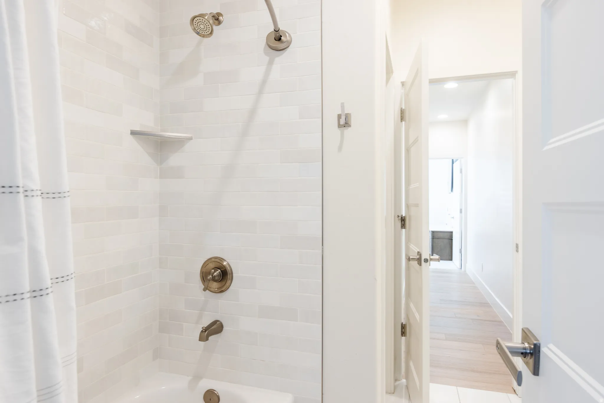 Full bath featuring shower / bathtub combination with curtain, light wood-style floors, and recessed lighting