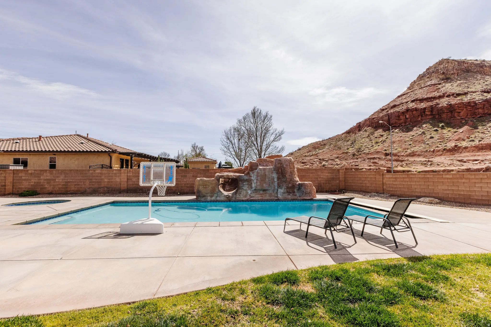 View of swimming pool featuring patio surround and a fenced backyard