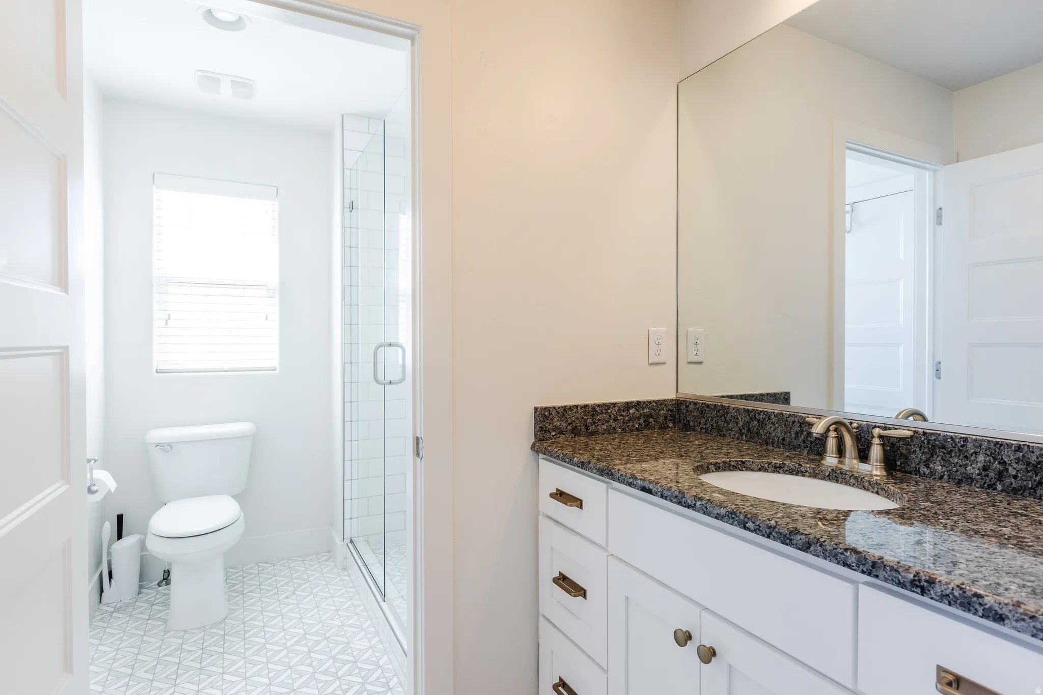 Bathroom with vanity and a stall shower