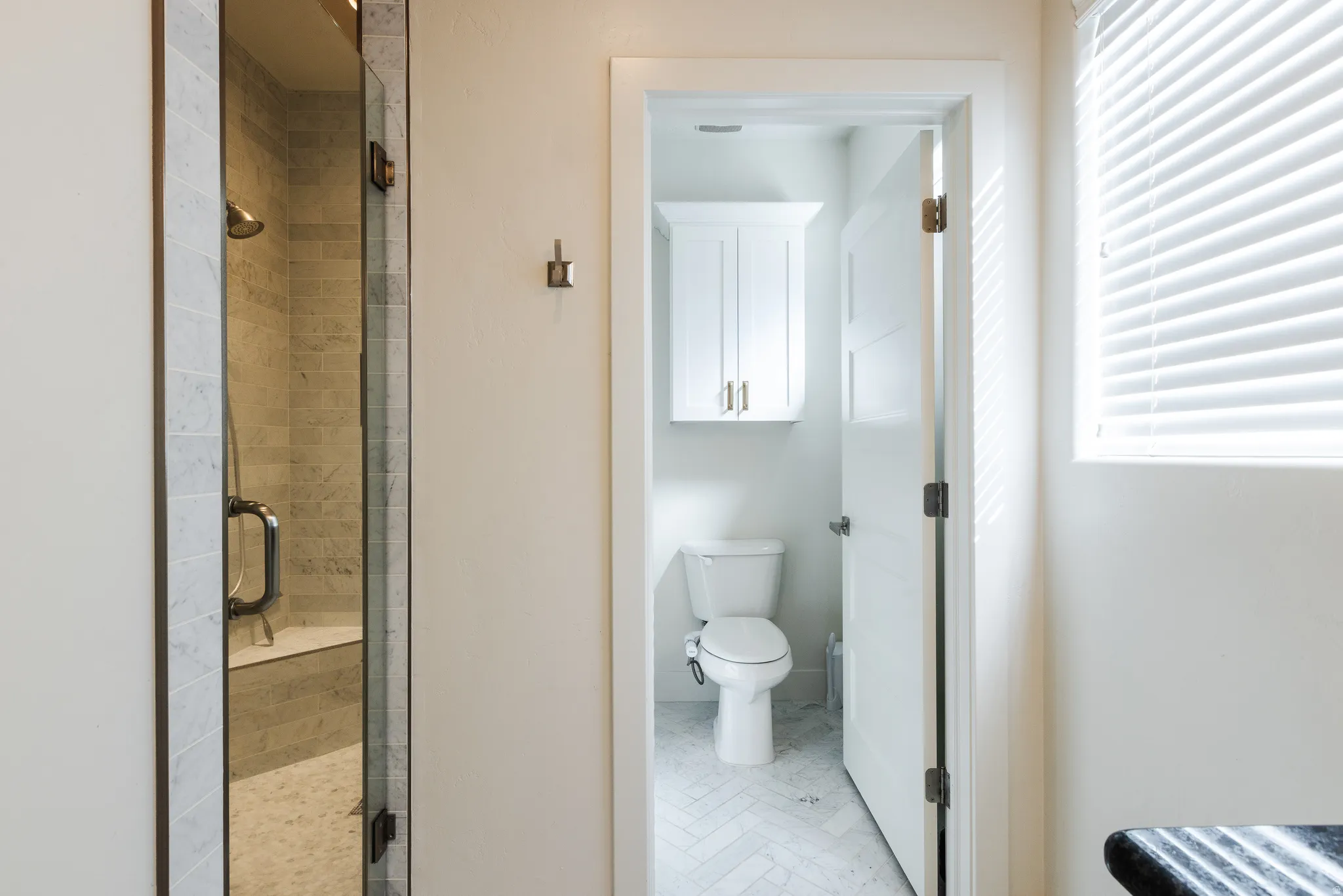 Bathroom featuring toilet and a stall shower